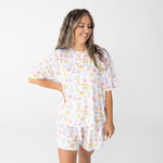 Women's short sleeve top and shorts set with pink scooters, lemons, palm trees, and postcard details