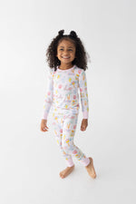Toddler two-piece pajamas in an Italian coast print with pink scooters, lemons, palm trees, and seashells.