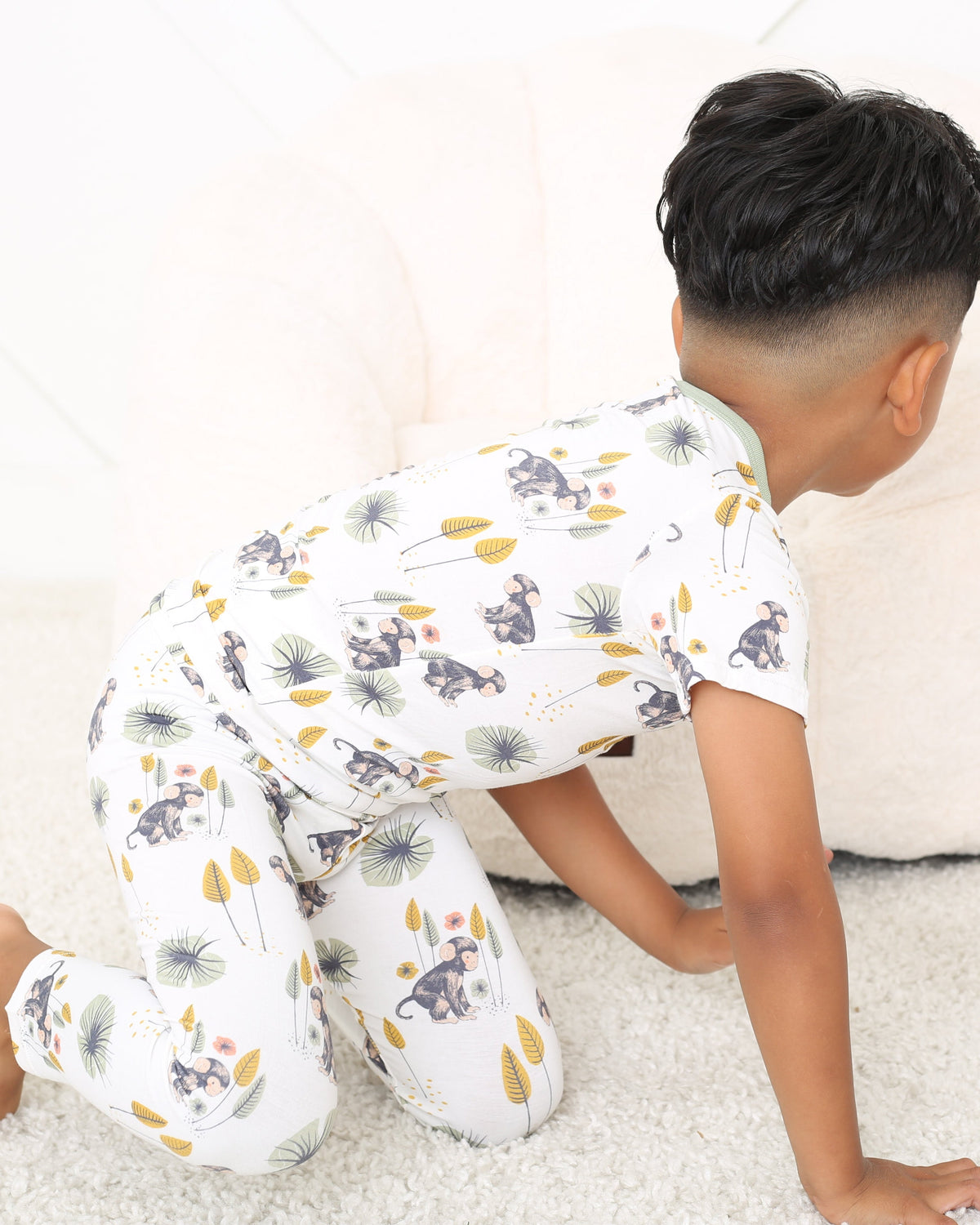 Two-piece pajama set with short sleeve top and long pants in a monkey print
