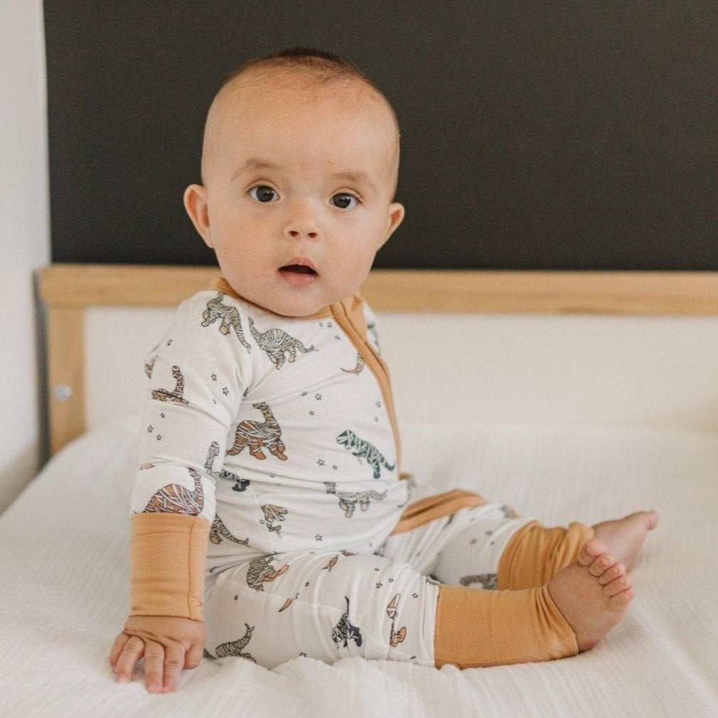 Convertible zippy romper in a Halloween mummy dinosaur print with foldover cuffs and feet.