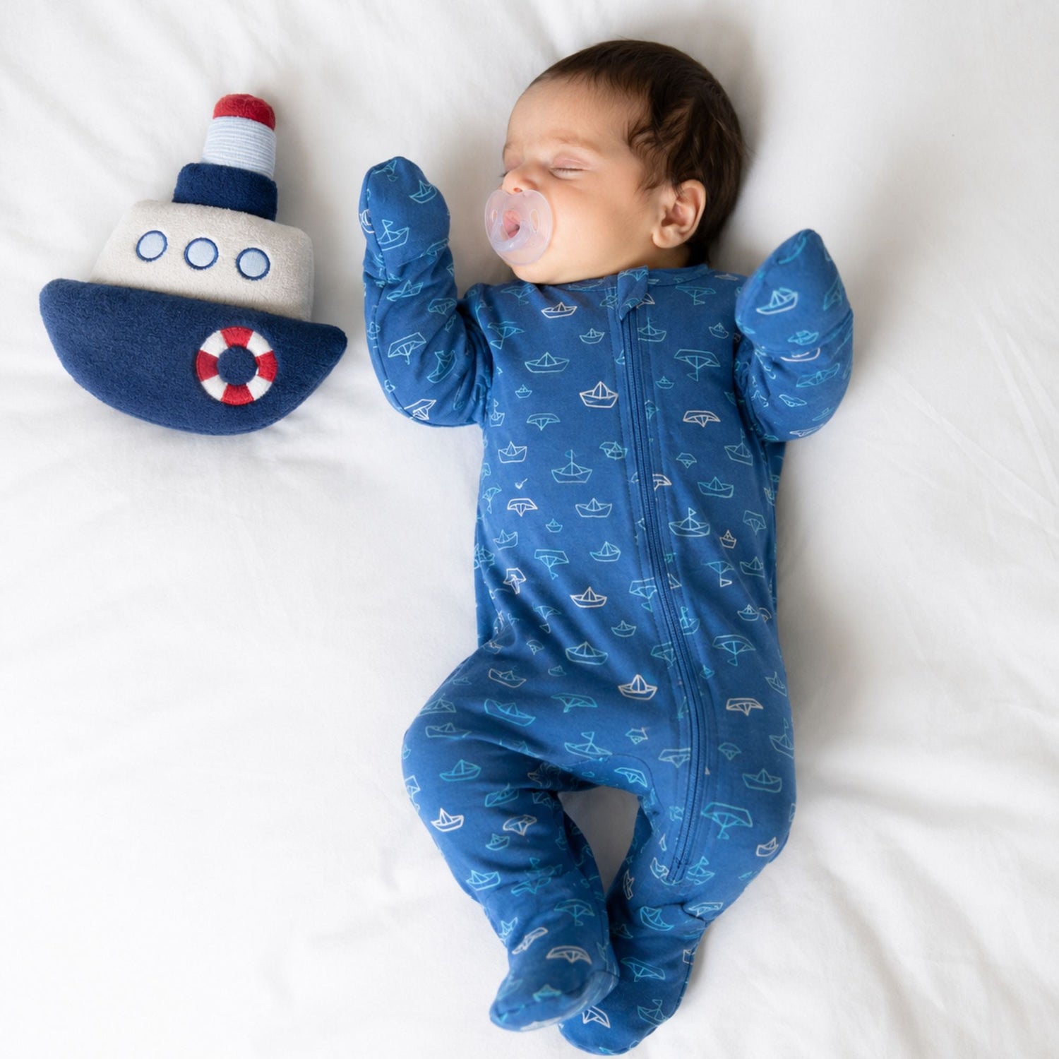 Baby footie pajamas in a nautical print with a full-length two-way front zipper.