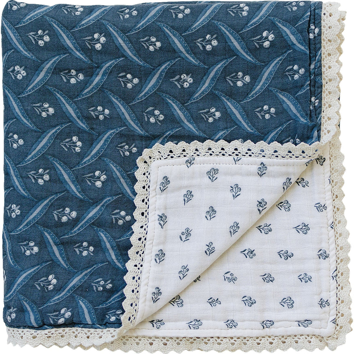 Navy berry and cream patterned muslin quilt with delicate lace trim edges, laid flat.