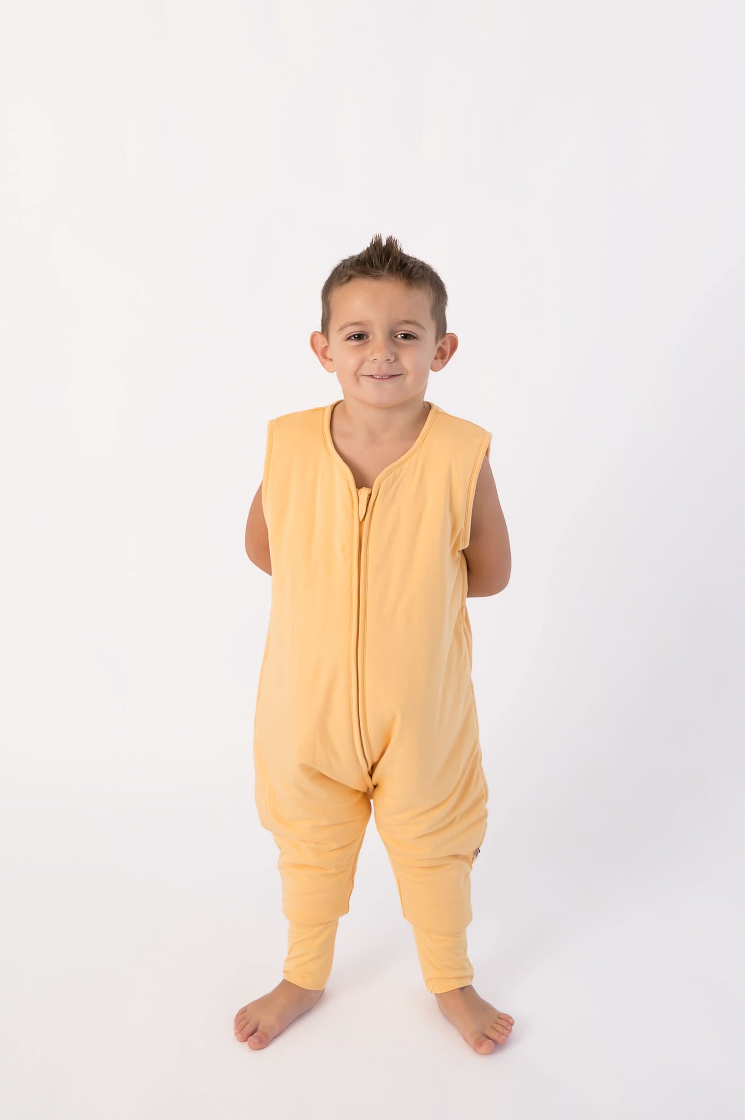 Papaya-colored bubble romper lounge suit with snap closures at the neck and legs