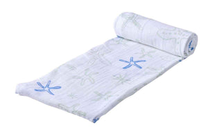 Cotton muslin baby swaddle blanket with a whimsical starfish print in an oceanic theme