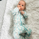 Norani Baby newborn organic footed onesie with contrast zipper.