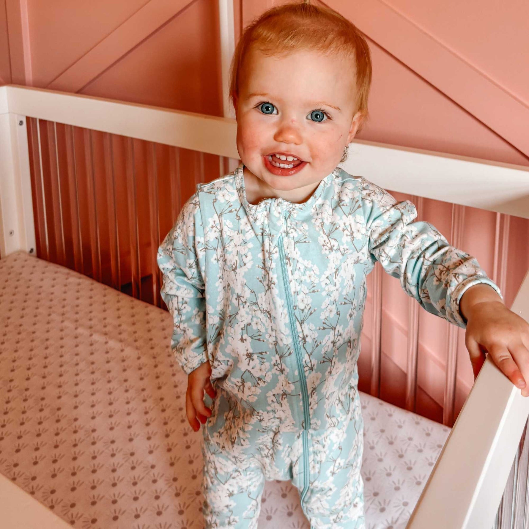 Norani Baby organic footed onesie with contrast zipper for newborns.