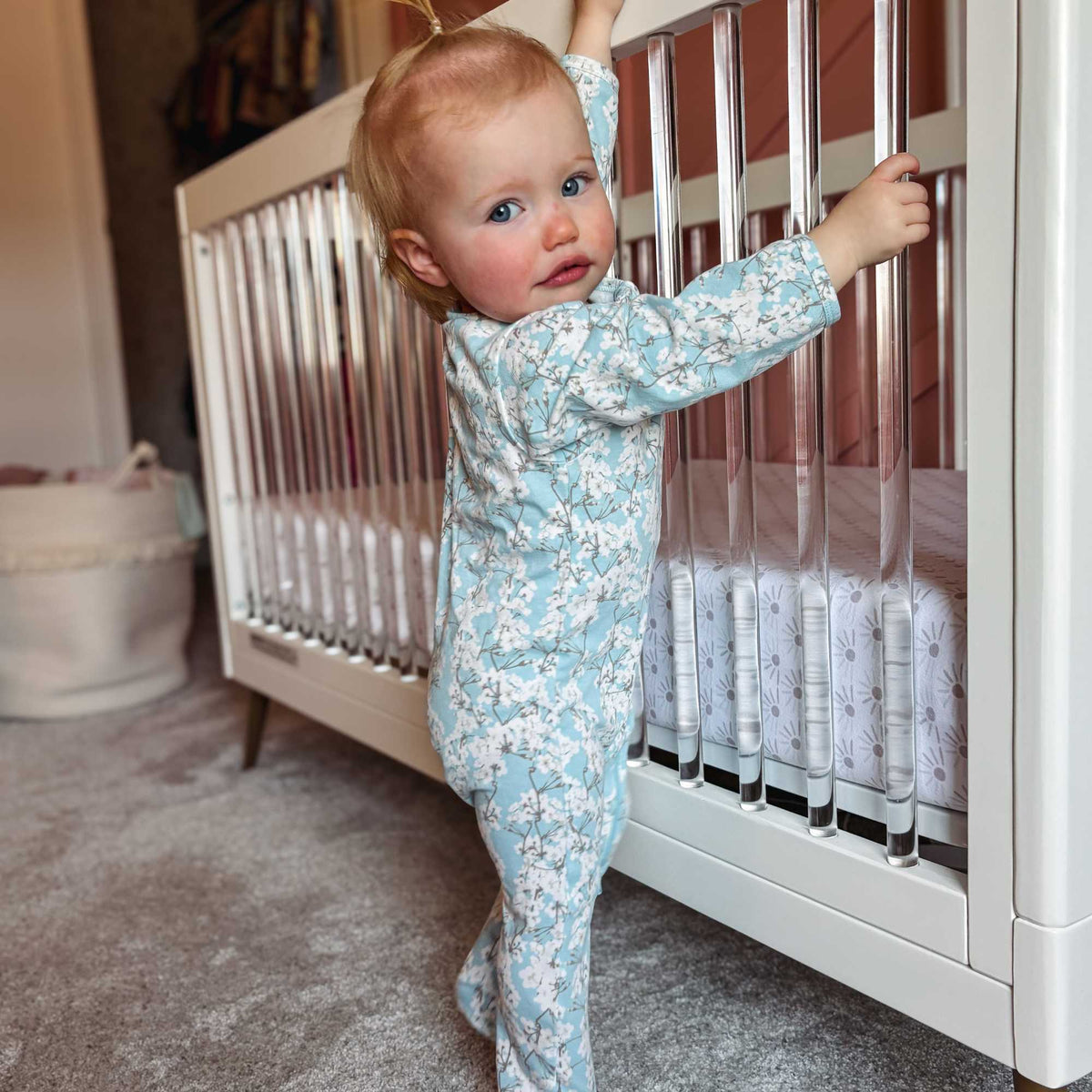 Norani Baby organic footed onesie with contrast zipper for newborns.
