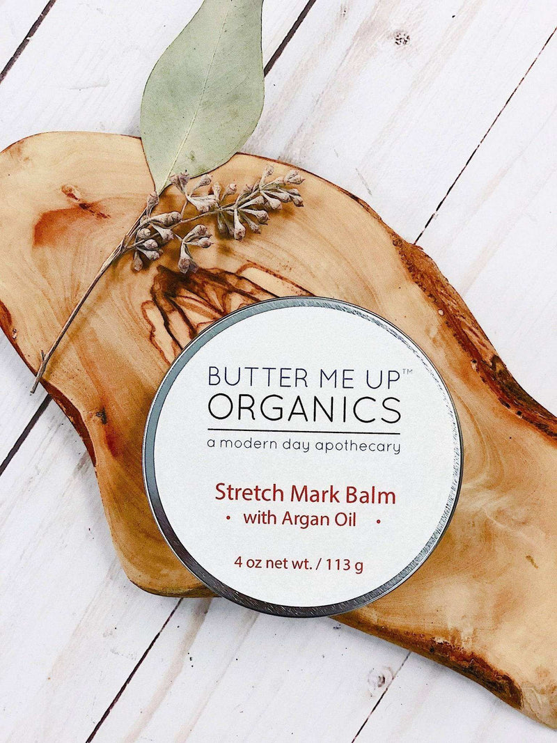 Organic Body Butter with Argan Oil on wooden surface, enhancing skin elasticity and preventing stretch marks.