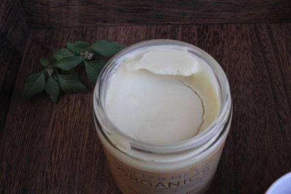 Organic Magnesium Lotion in a glass jar with smooth, creamy texture.