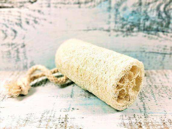 Organic natural loofah on rustic background, ideal for exfoliation and skincare.