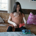Modern Nursery organic cotton baby wrap for comfortable infant carrying.
