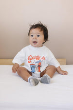 Little Joy Co. organic baby t-shirt romper with 'Party in the USA' graphic, front view