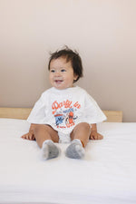 Little Joy Co. organic baby t-shirt romper with 'Party in the USA' graphic, front view
