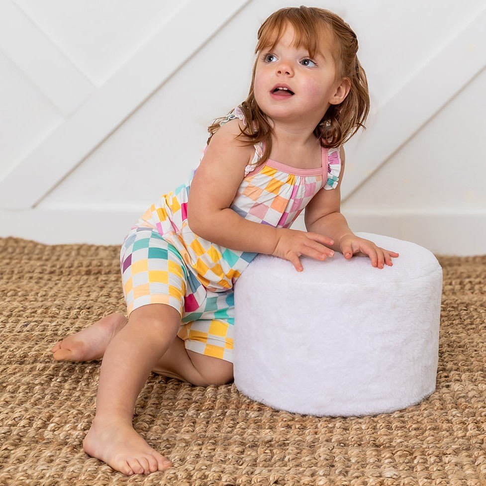 Baby two-piece set with pastel checkered print flutter-sleeve tank top and matching snug shorts.