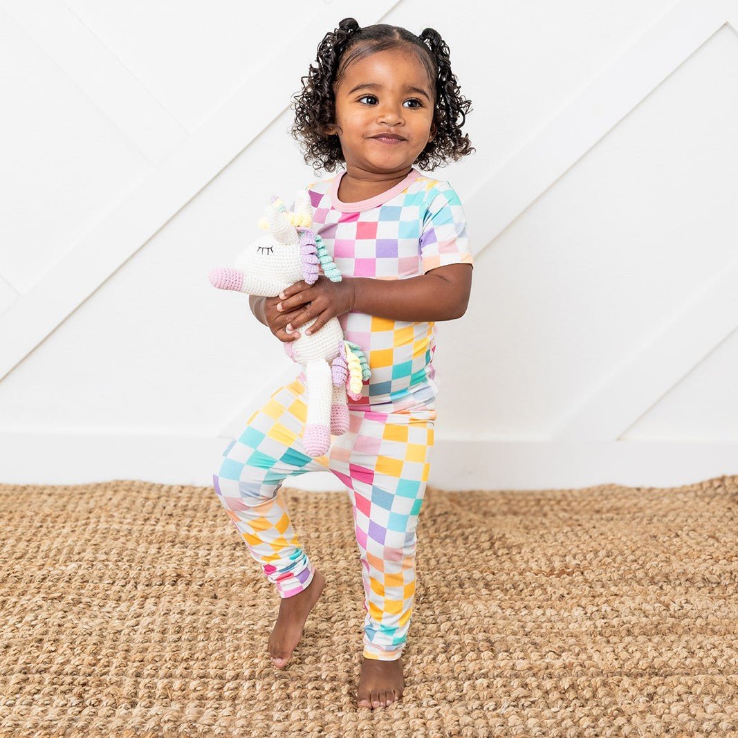 Short sleeve baby pajama set in a pastel colorful checkered print, top and matching pants.
