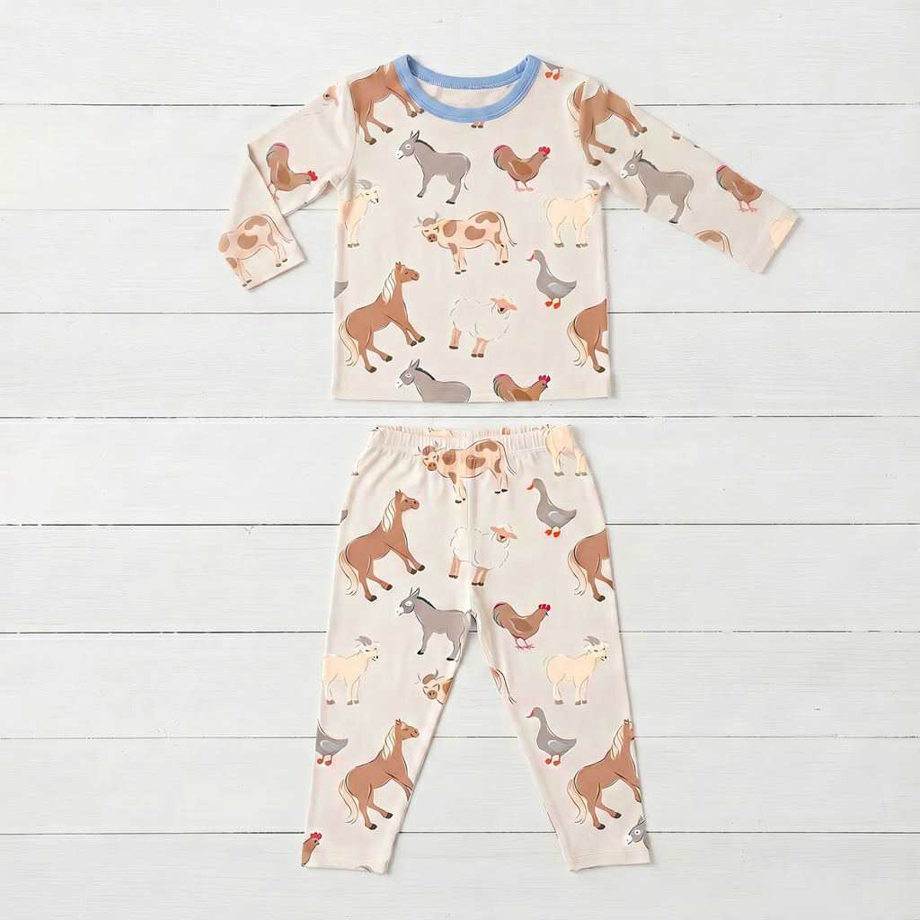 Two-piece long sleeve baby pajama set with farm animal Pasture Pals print, top and matching pants