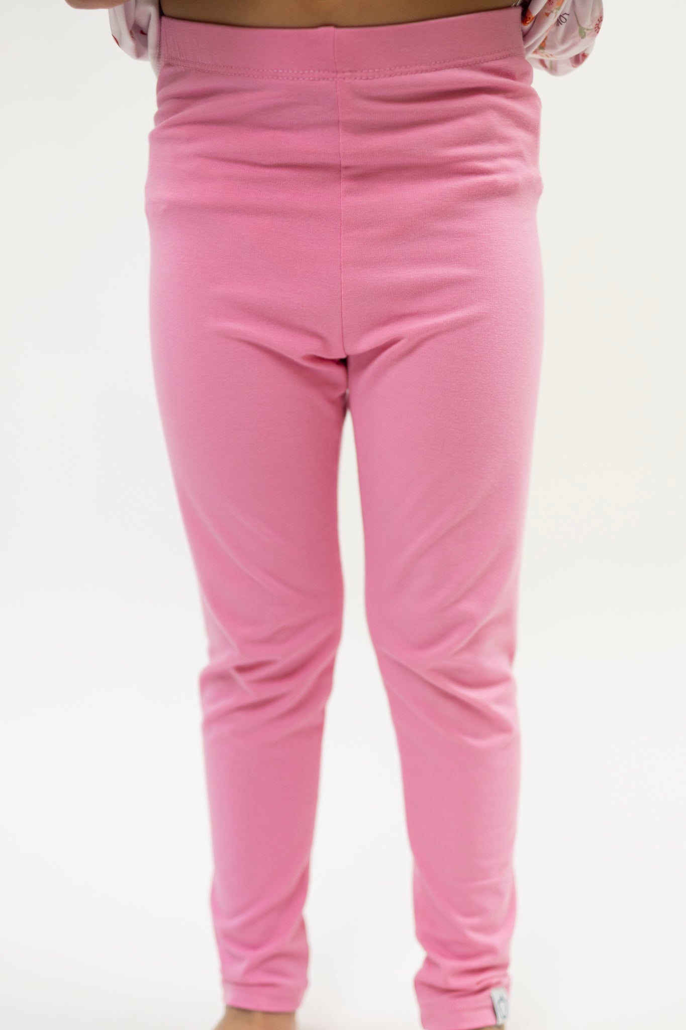 Pink toddler leggings in soft bamboo fabric with a full-length fitted cut.