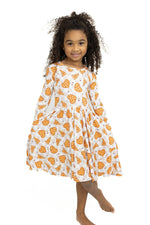 Long sleeve twirl dress in neutral checker print covered with heart-shaped pizzas
