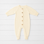 Buttercream pointelle knit baby footie romper with front button placket and long sleeves with ribbed cuffs