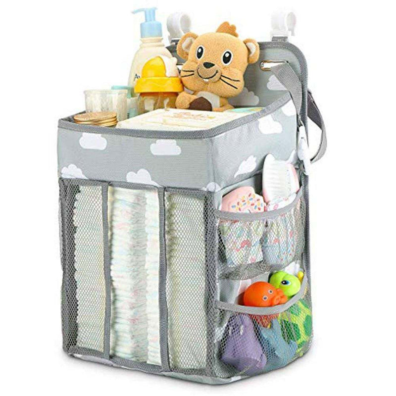 Portable baby crib organizer with multiple compartments, filled with baby items, designed for easy storage and accessibility.