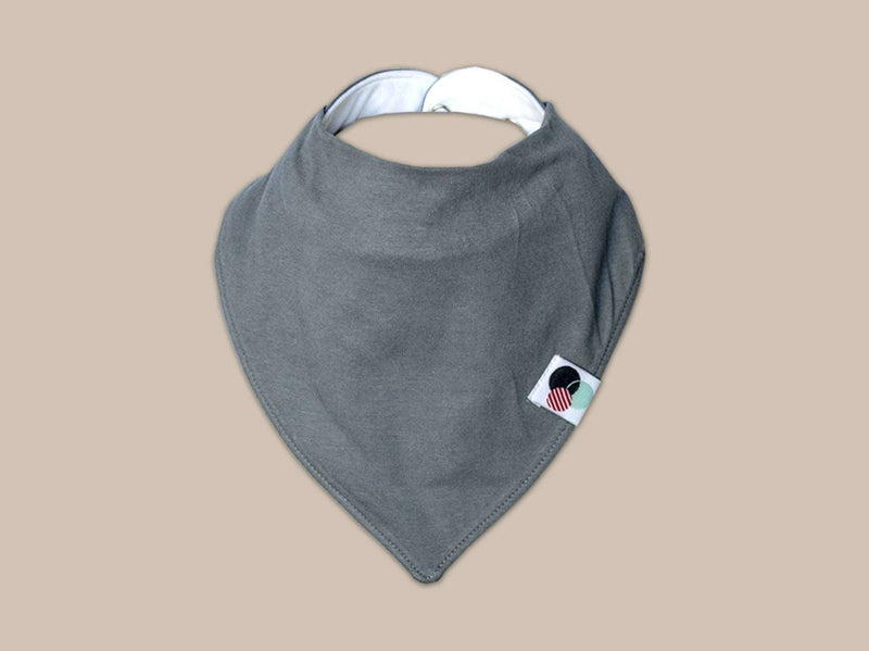 Organic cotton baby bandana bib in solid grey with adjustable snaps, highly absorbent, suitable for ages 3-24 months.