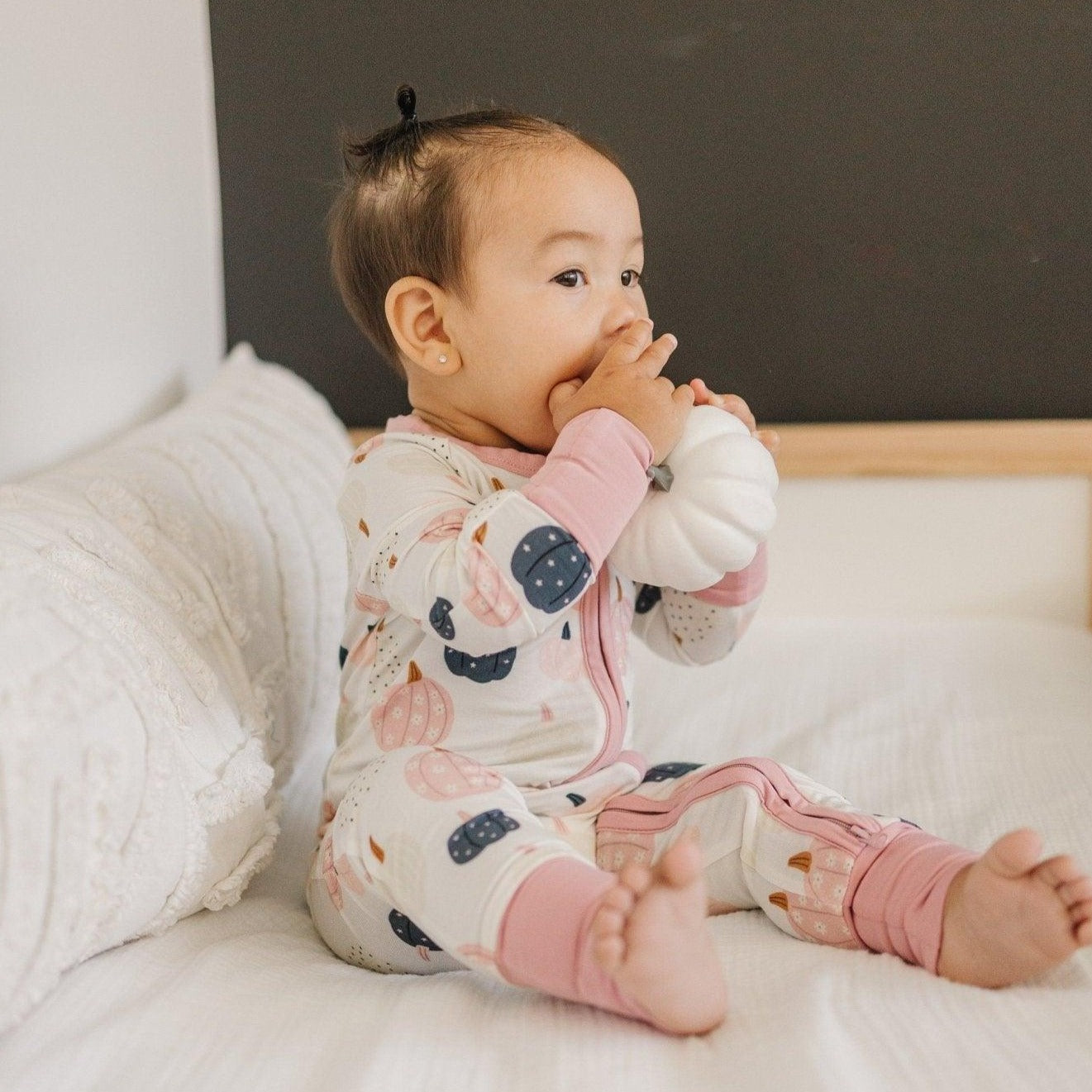 Pumpkin-print romper with a full-length zipper and foldover cuffs and feet.