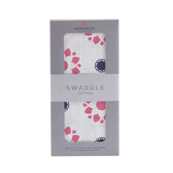 Cotton muslin swaddle blanket in Primrose Indigo print with a soft floral design on an indigo background