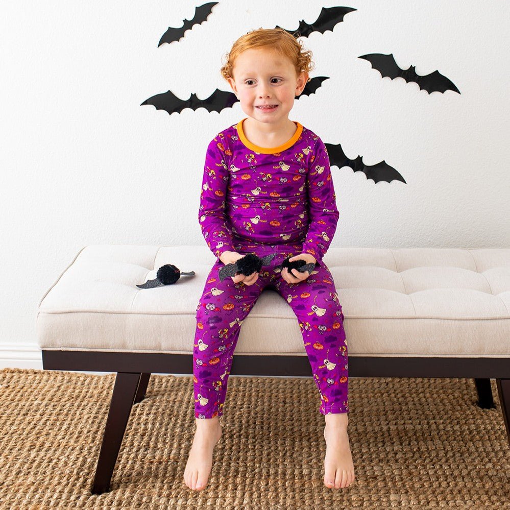 Two-piece long-sleeve pajama set in purple with a ghost Boo Crew print, matching top and pants.