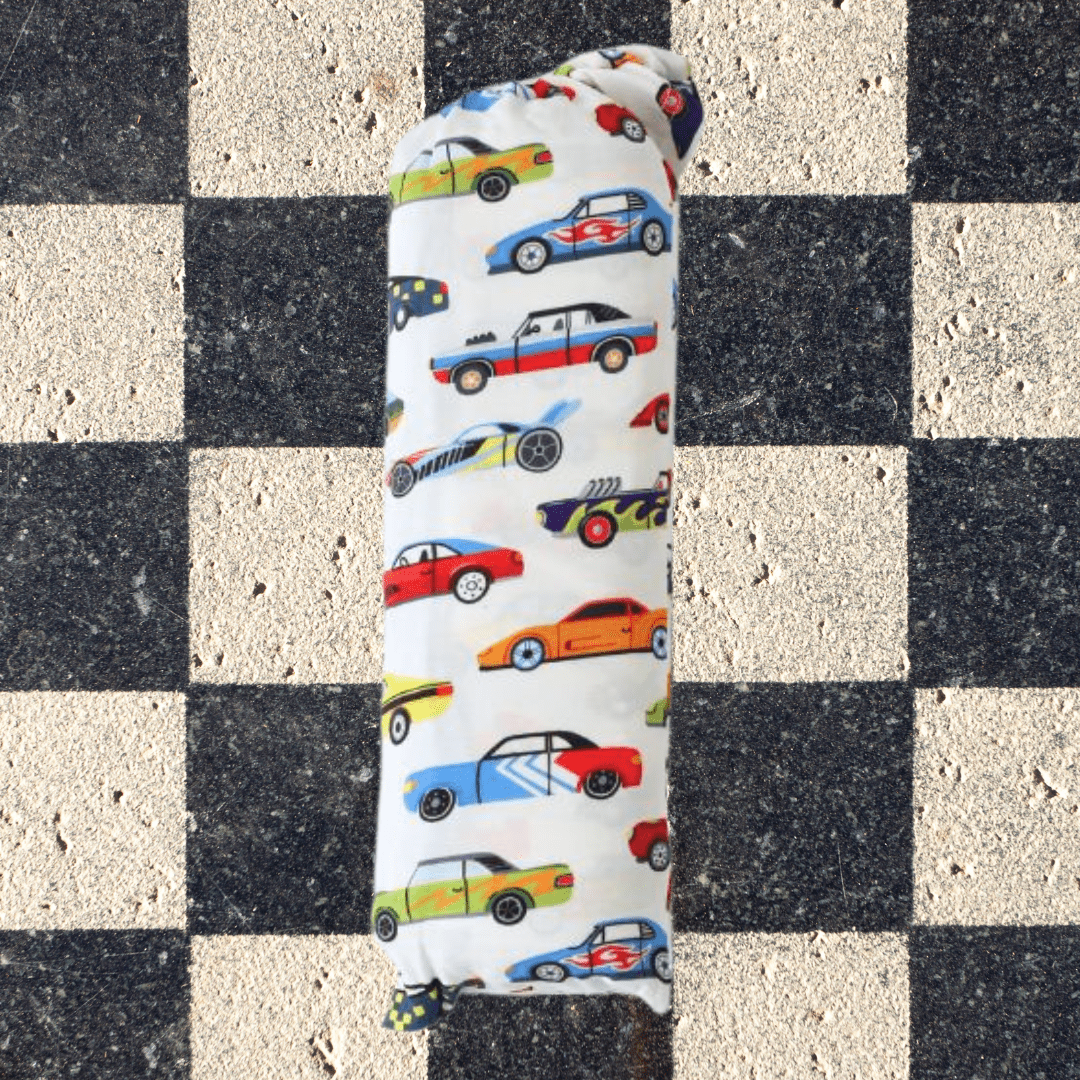 Baby swaddle blanket printed with classic racing cars in a repeating pattern