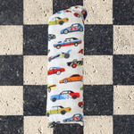 Baby swaddle blanket printed with classic racing cars in a repeating pattern