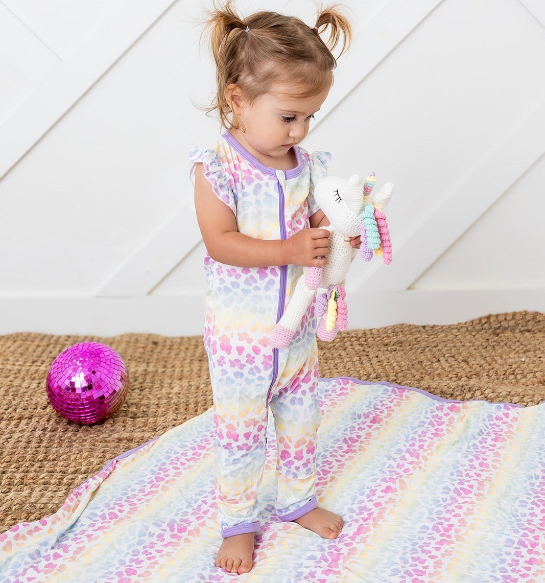 Short-sleeve baby romper in pink with flutter sleeves and a full-length zipper down the front.