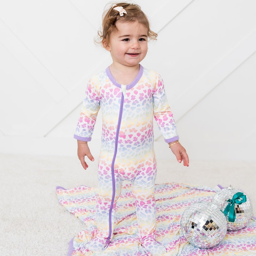 Baby footie pajamas in a rainbow leopard and flower print with a full-length two-way zipper and fold-over mittens.