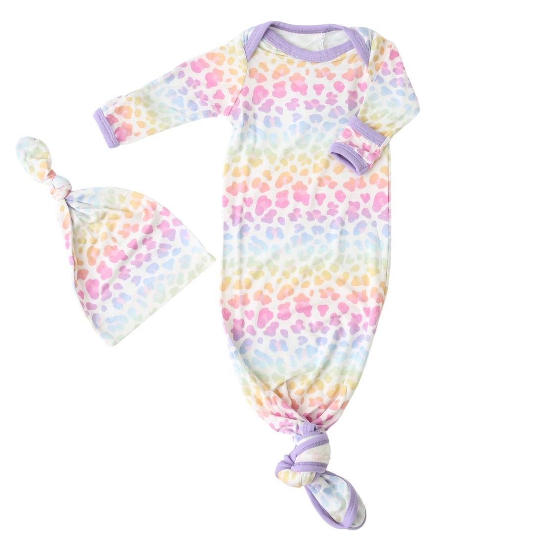 Newborn knotted gown with matching hat in the Aurora print, showing fold-over mittens at the sleeves