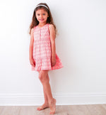 Hot pink baby dress with yellow and pink floral print, ruffle detail, and back-button pull-on style.