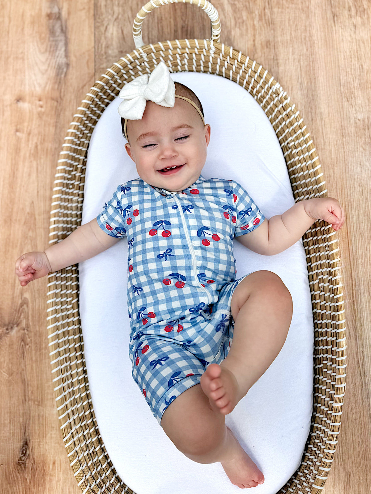 Toddler wearing Red, White & Blue Cherry Gingham Bamboo Shorty Pajamas, playing happily.