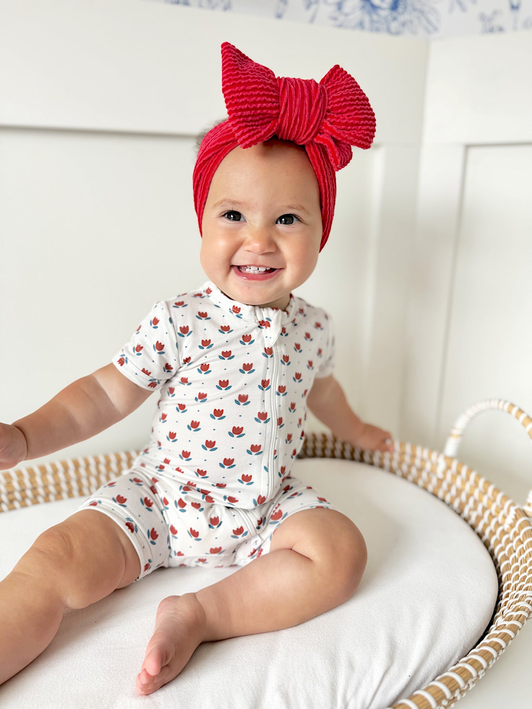 Little Joy Co. baby wearing a soft bamboo viscose shorty romper, smiling comfortably.