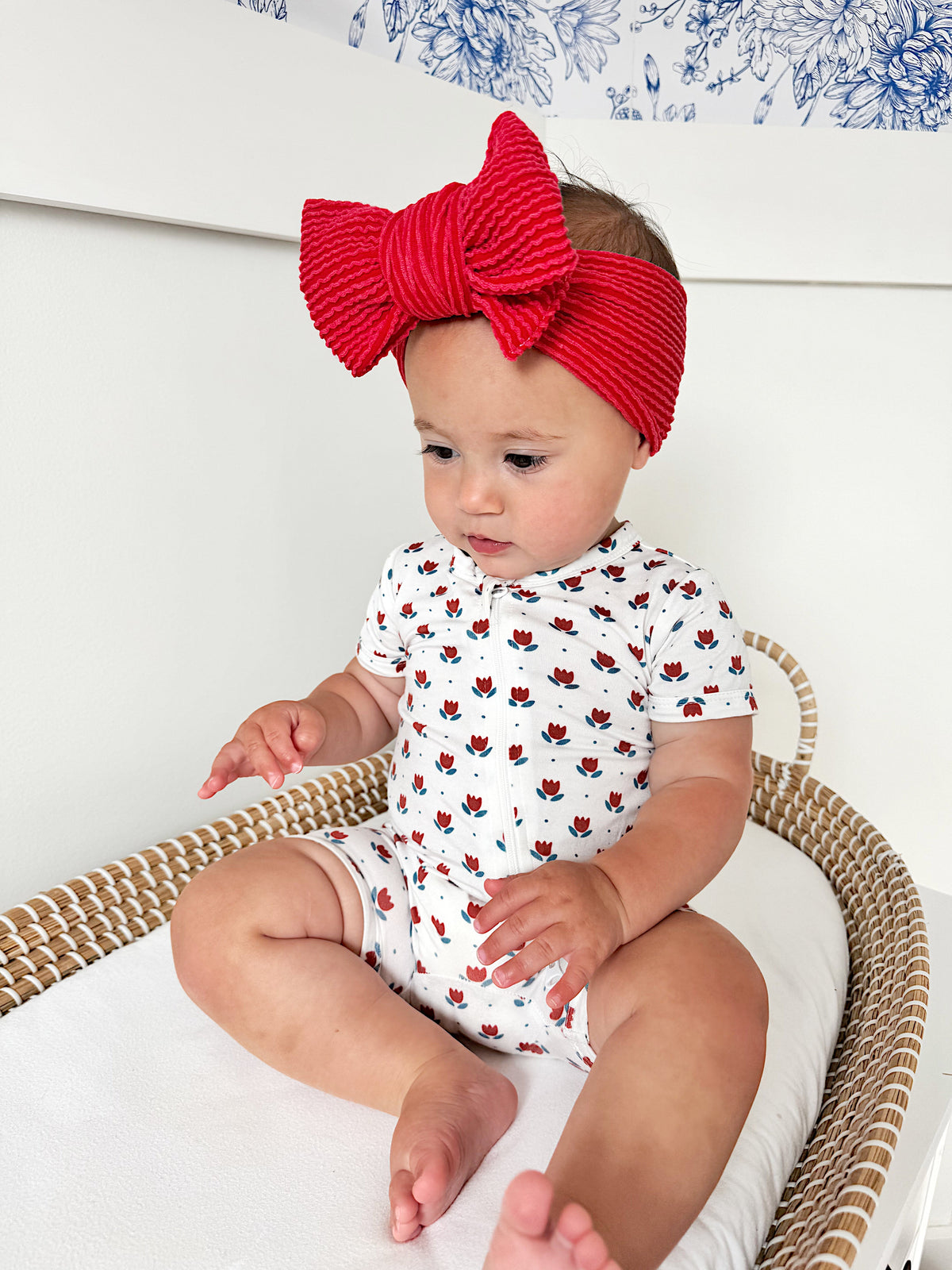 Little Joy Co. baby wearing a soft bamboo viscose shorty romper, smiling comfortably.