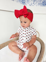 Little Joy Co. baby wearing a soft bamboo viscose shorty romper, smiling comfortably.