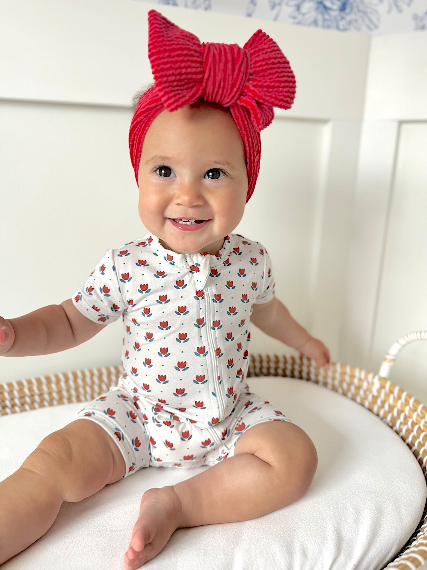 Little Joy Co. baby wearing a soft bamboo viscose shorty romper, smiling comfortably.