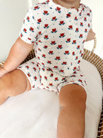 Little Joy Co. baby wearing a soft bamboo viscose shorty romper, smiling comfortably.