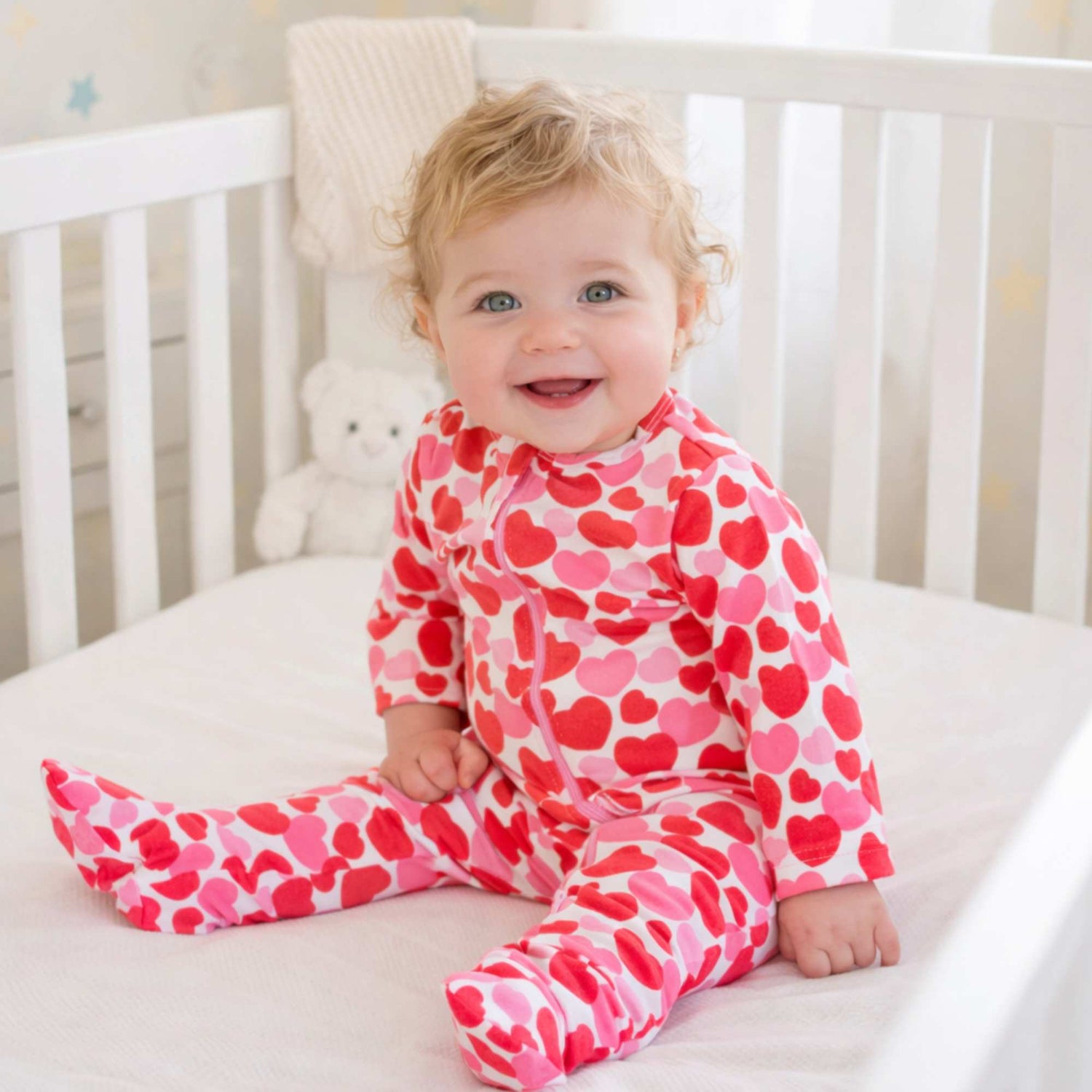 Norani Baby organic footie pajamas with red and pink hearts.