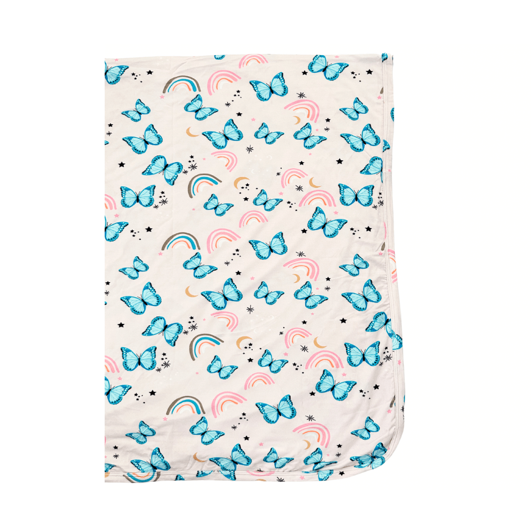 Baby swaddle blanket with a retro butterfly print in soft muted colors, laid flat.