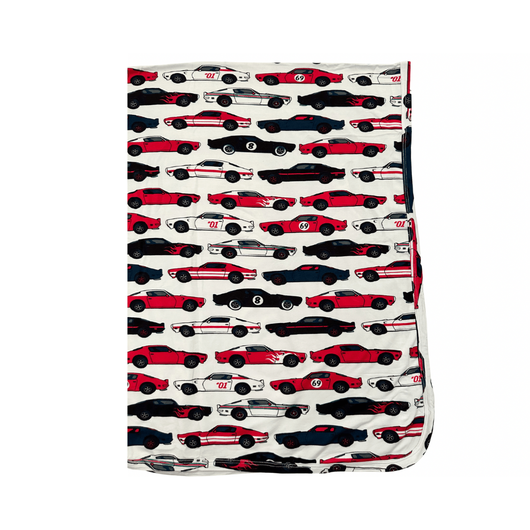 Square baby swaddle blanket with a colorful print of race cars and sports cars.