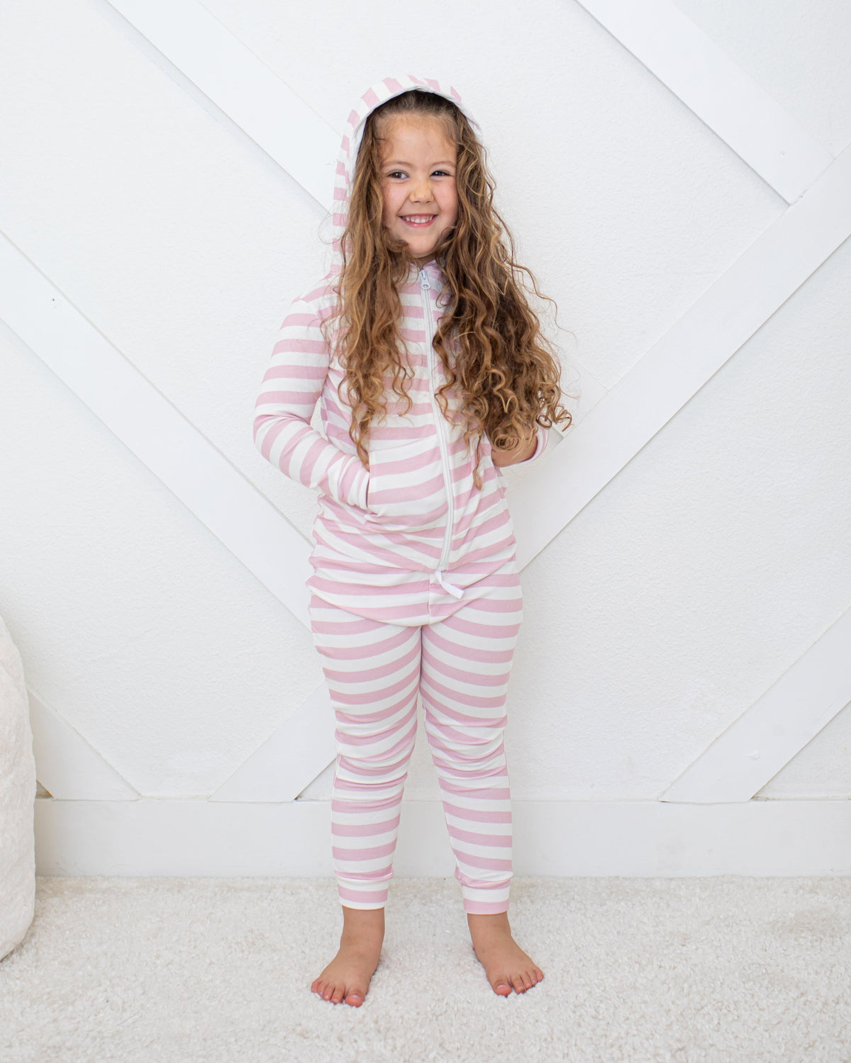 Baby zip-up hoodie in blush and white stripes with a lined hood and kangaroo pockets