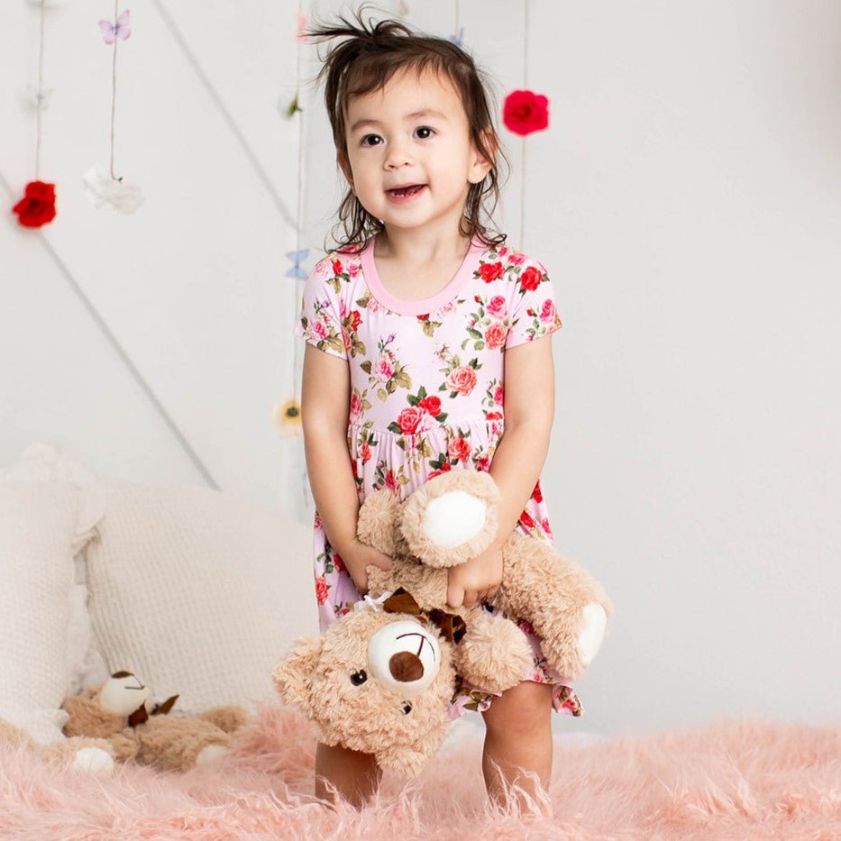 Pink rosebud-print toddler dress with sleeves, shown flat.