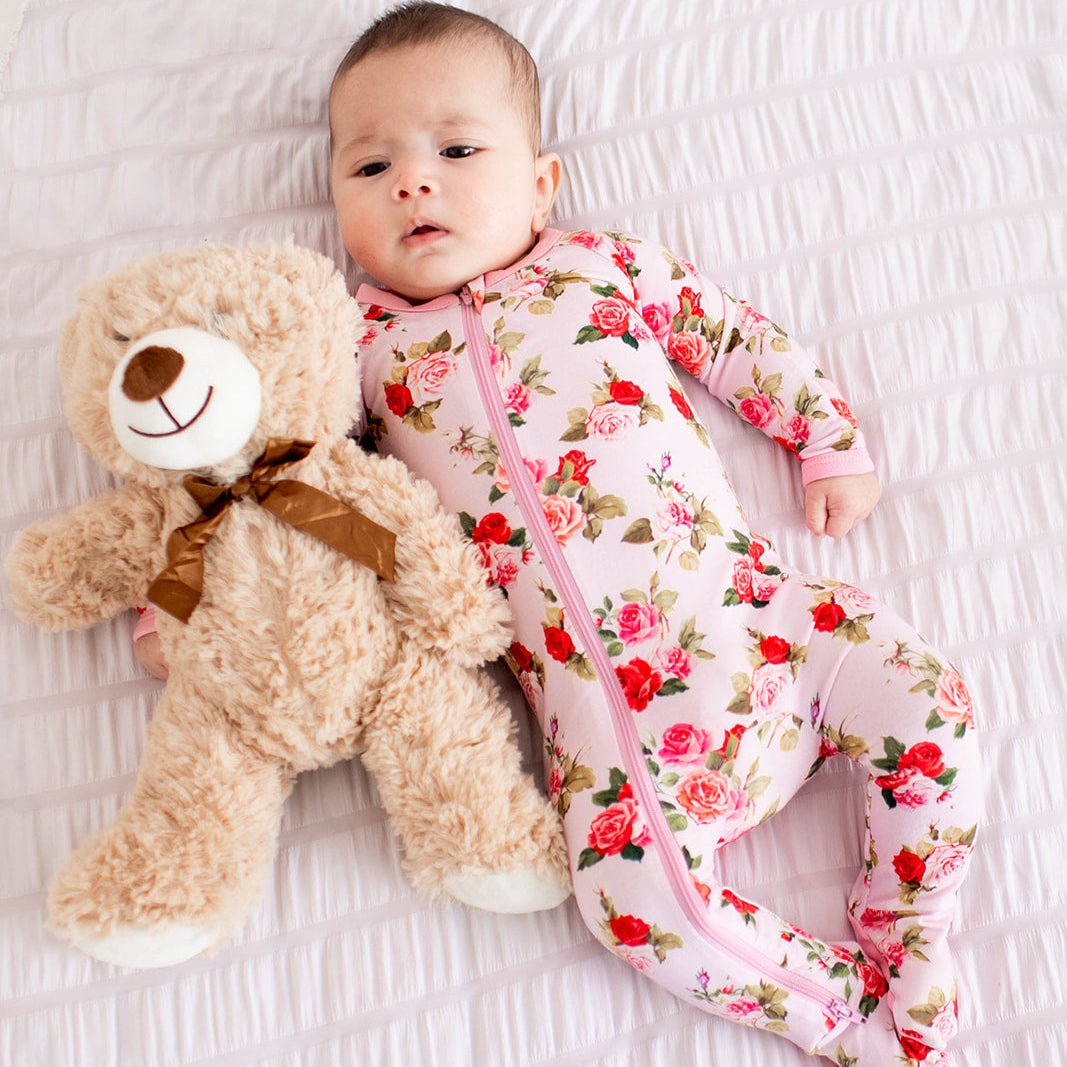Baby footie pajamas in an all-over pink roses print with a full-length front zipper.