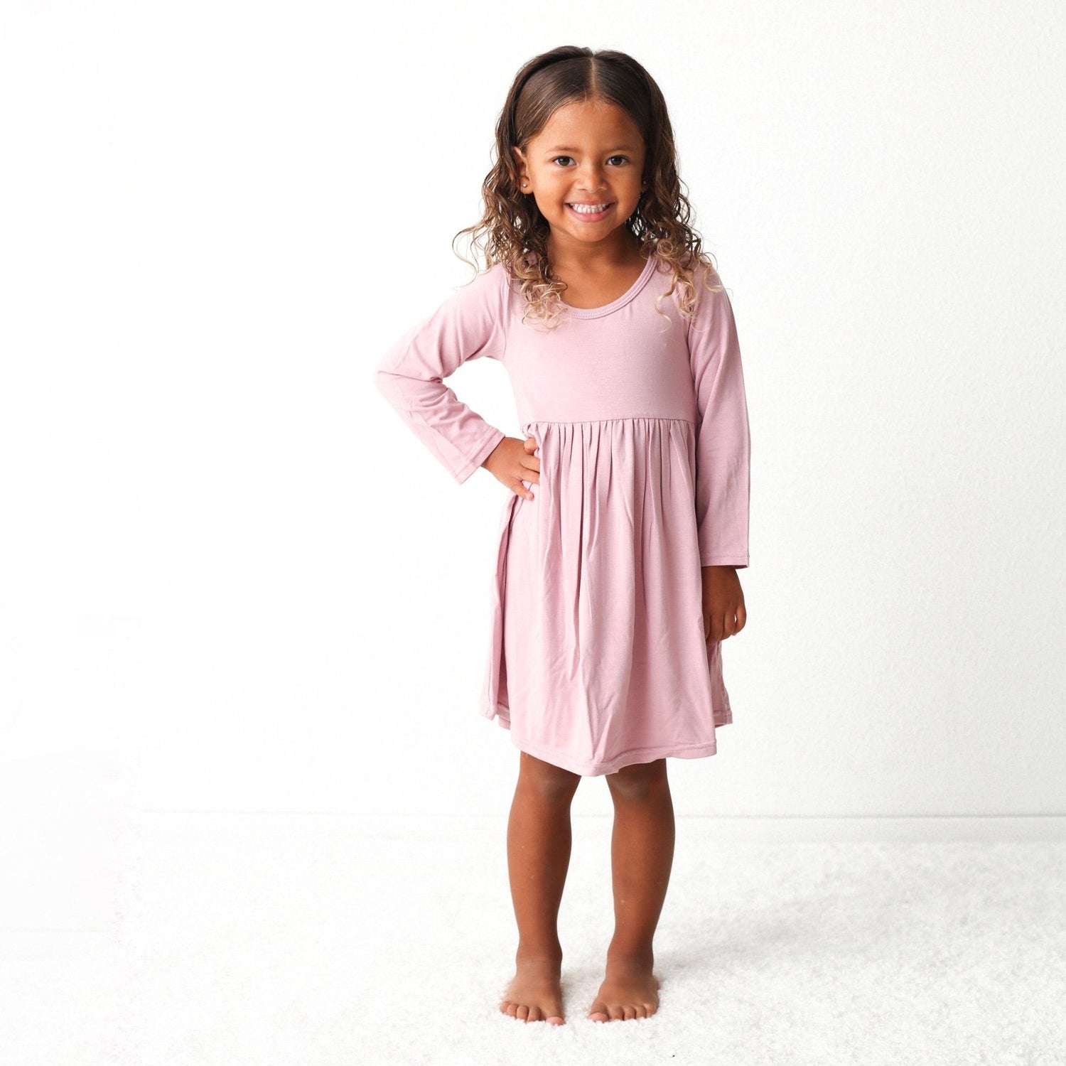 Pink long sleeve dress worn by a toddler girl
