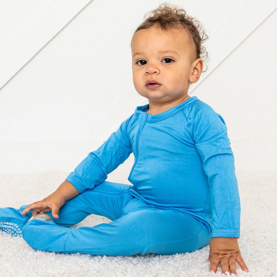 Royal blue footed sleeper with a full-length two-way zipper and footed legs.
