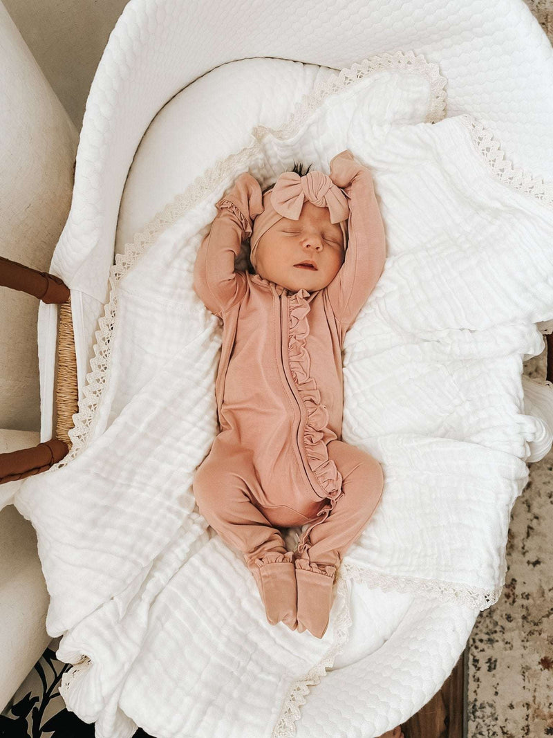 Dusty pink ruffle zipper one piece outfit for babies in soft bamboo viscose.
