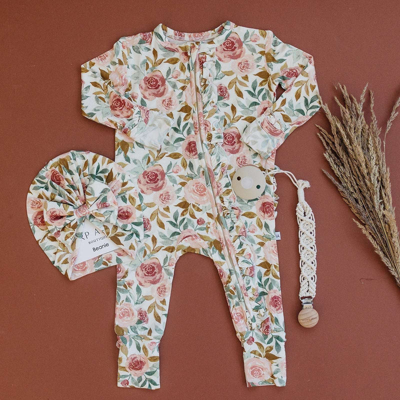 Ruffle Zipper One Piece in dusty pink floral design with bamboo material and 2-way zipper.